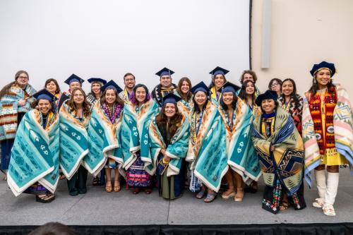 Native American graduates with blankets